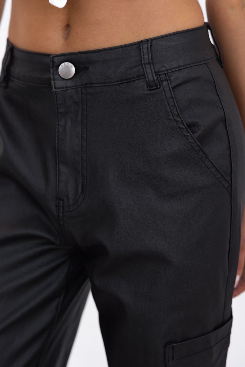 Close-up of Deniz Cargo Pants in faux leather, featuring wide legs, pockets, and a mid-low waist fit.