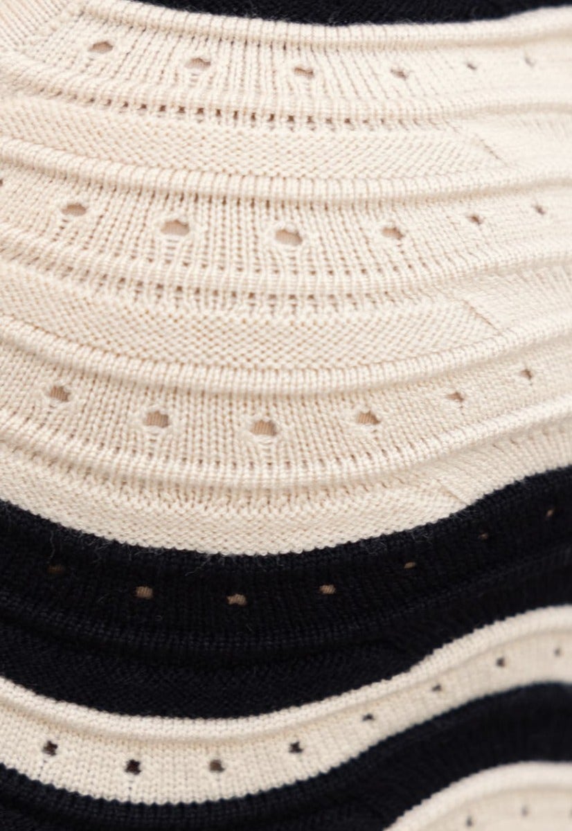 Close-up of Alanis Top fabric showcasing scoop neckline and semi open weave in black and cream stripes.