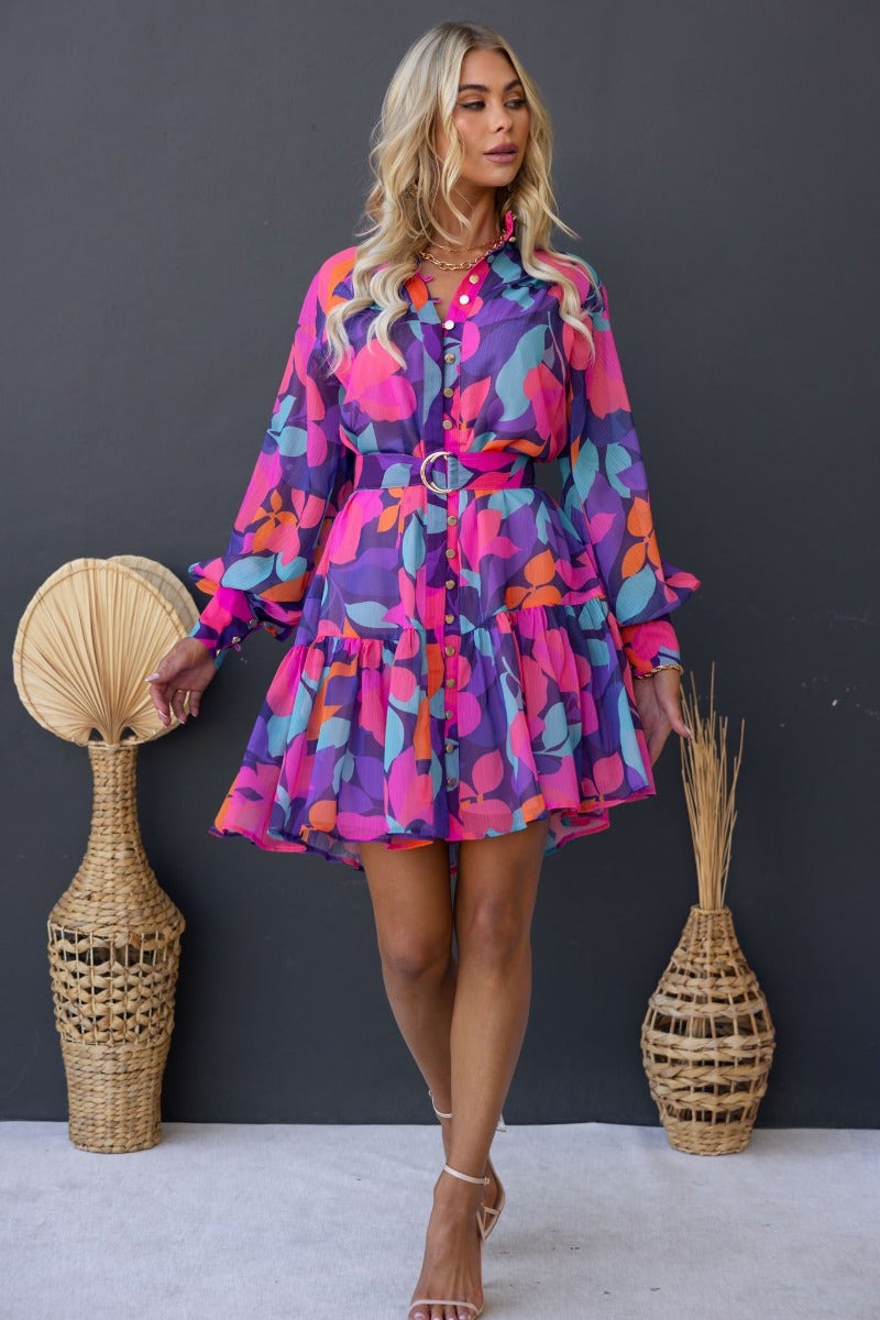 Model wearing the Orazio multi-colour print dress with a high neckline and button-up front, styled with a removable belt.