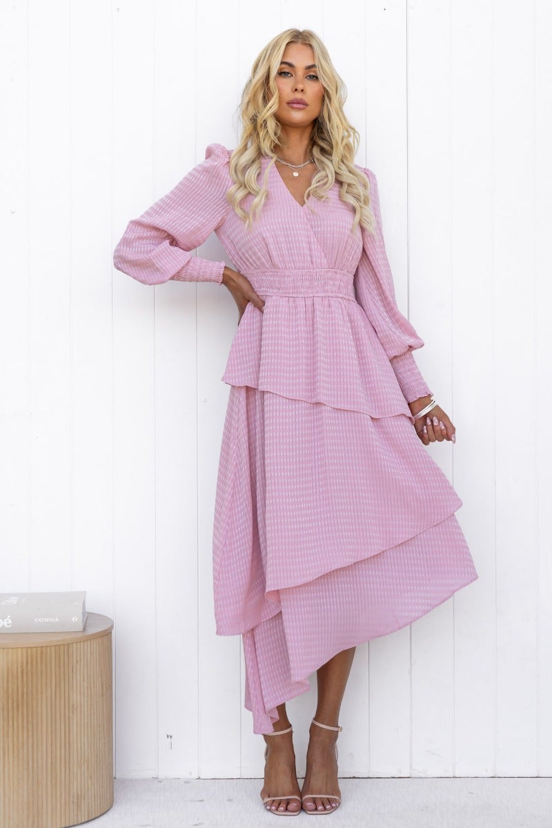 Briena Midi Dress in pink, featuring V-neckline, multi-tier ruffle skirt, and asymmetrical hemline.