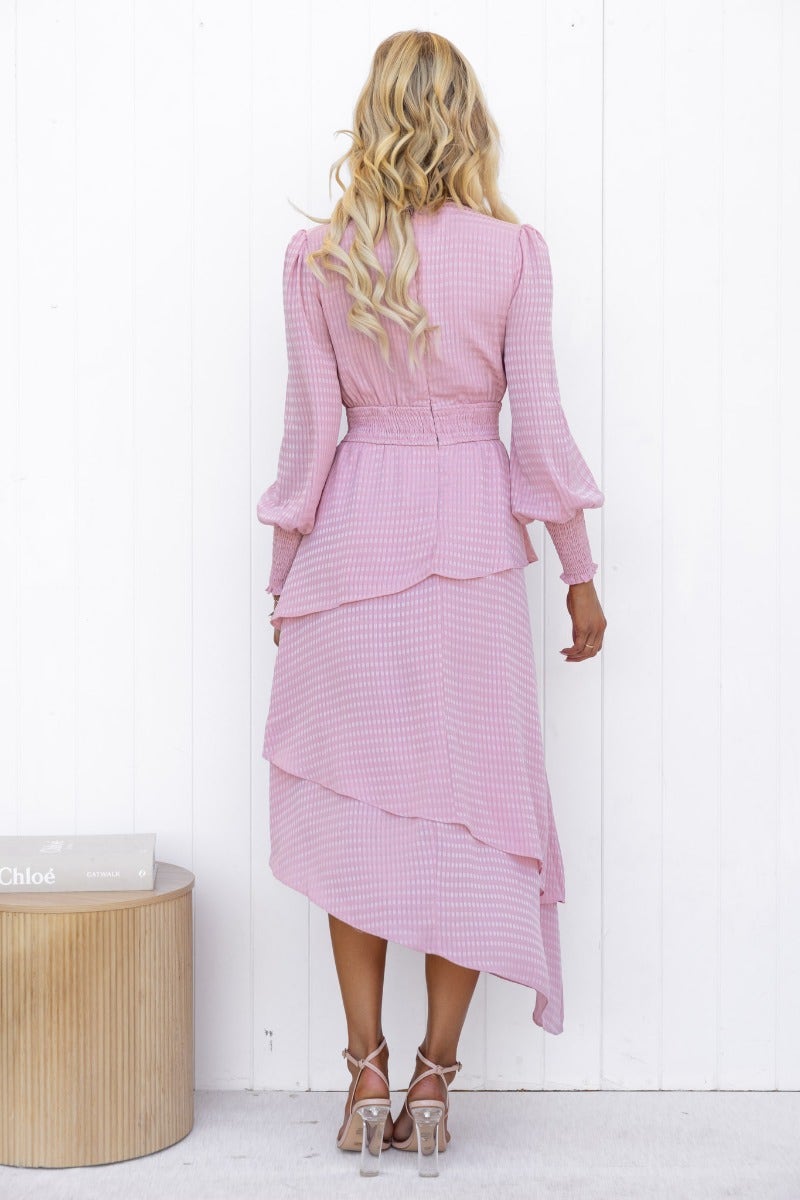 Back view of Briena Midi Dress featuring a multi-tier ruffle skirt, V-neckline, and elastic waistband in light pink.