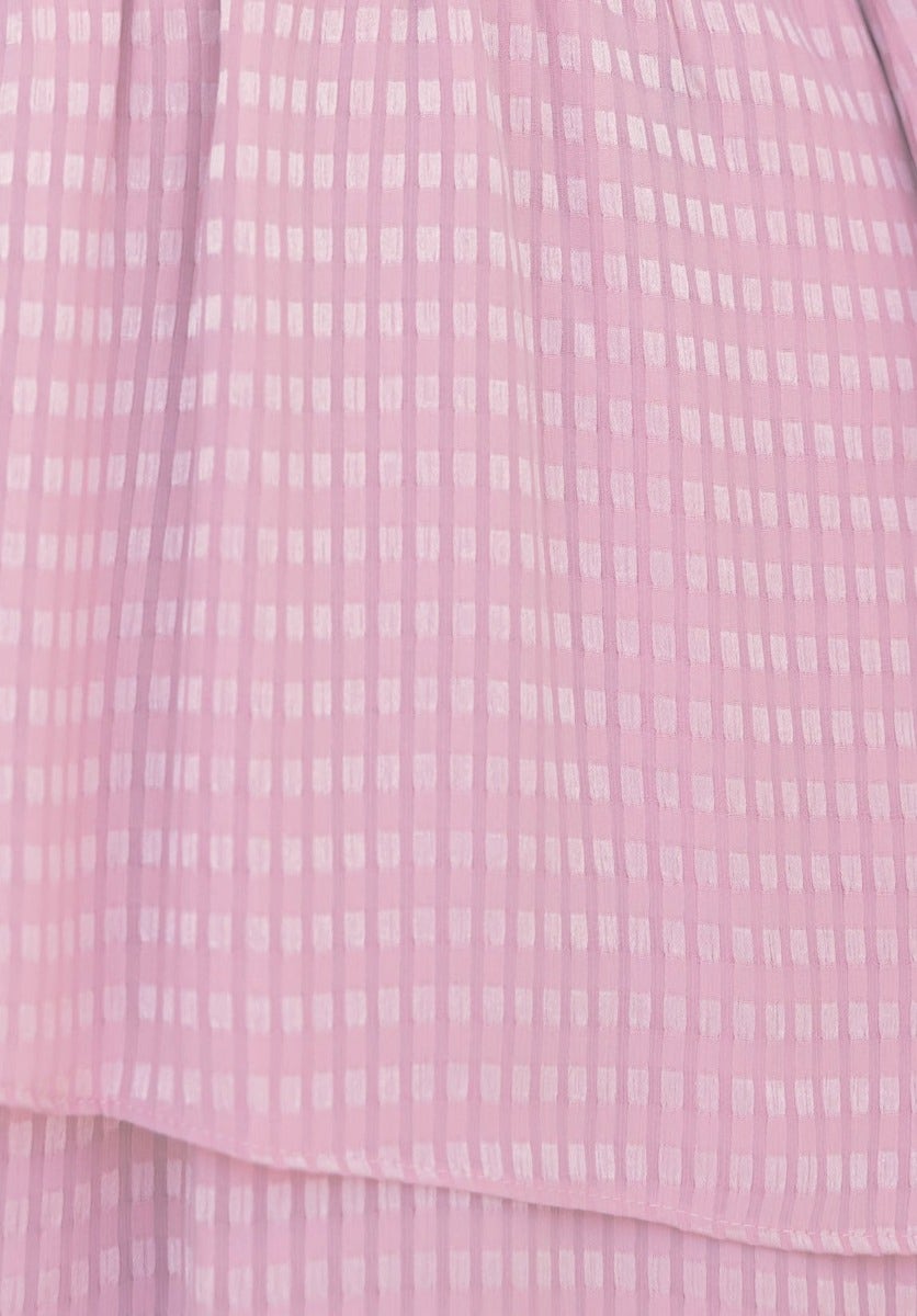 Close-up of lightly textured pink fabric with white grid pattern, perfect for the Briena Midi Dress.