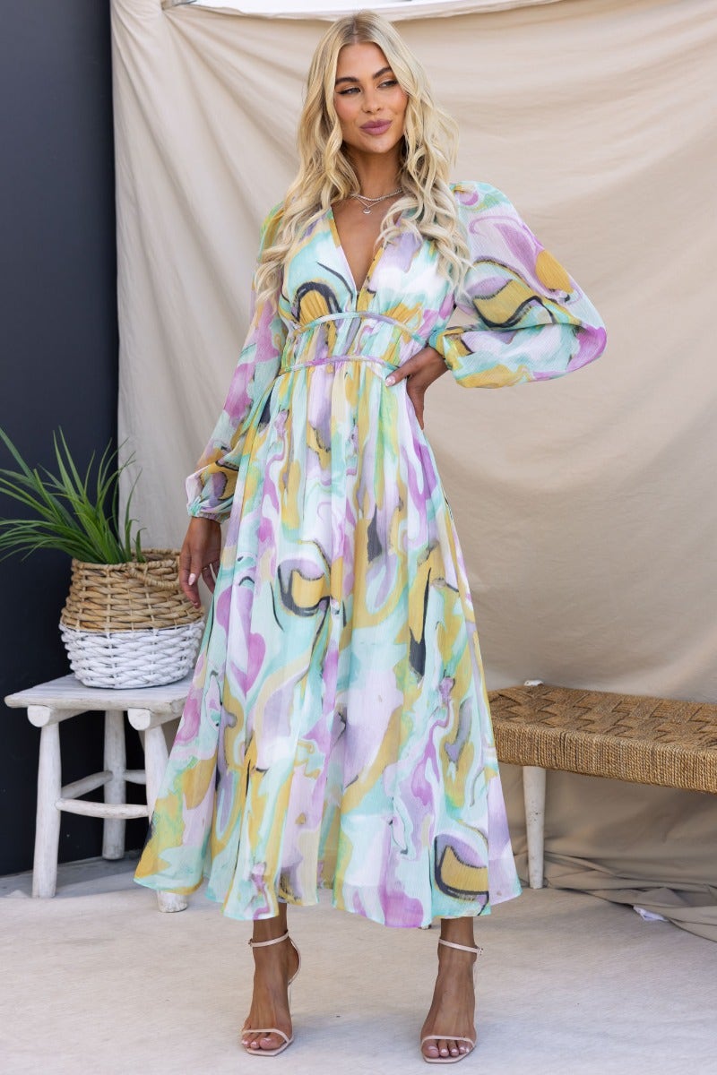 Haelyn Maxi Dress featuring a multi-colour print, V-neckline, elastic cuffs, and a flowing silhouette.