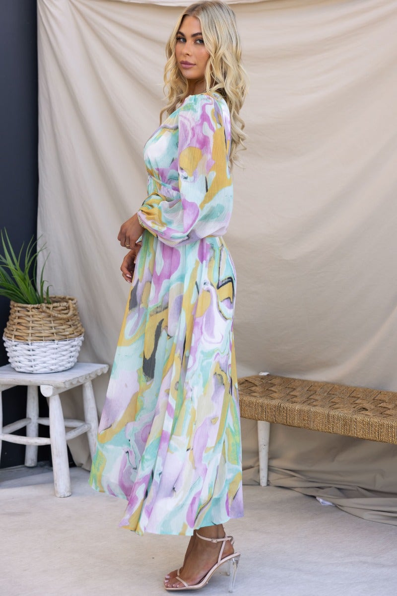 Side view of a multi-colour print Haelyn Maxi Dress featuring a V-neckline and elastic cuffs.