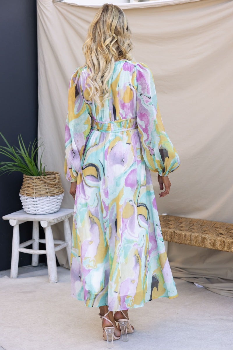 Back view of the Haelyn Maxi Dress featuring a multi-colour print, V-neckline, and elastic cuffs.
