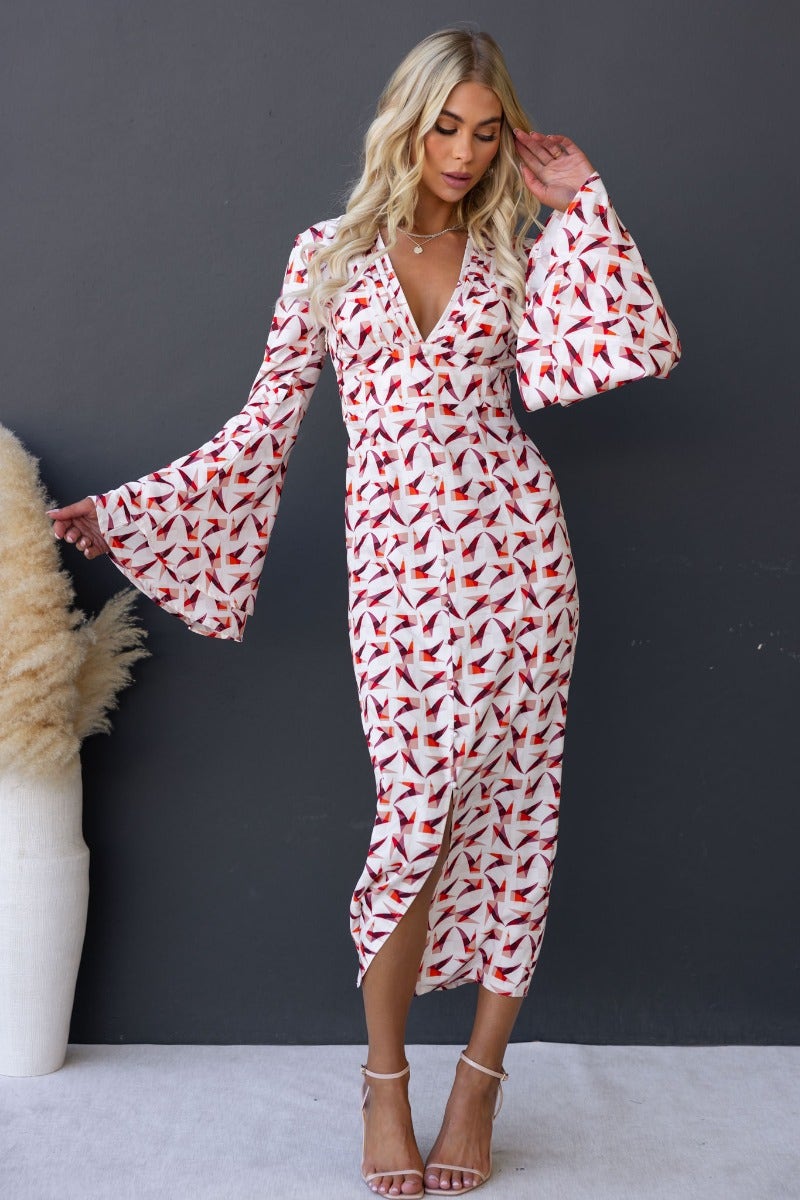 Kiran Maxi Dress featuring a multi-color print, V-neckline, faux buttons, flare sleeves, and a front split.