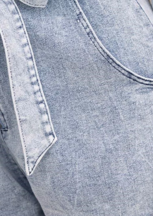 Close-up of Rover Denim Playsuit fabric showcasing the light wash denim and removable belt detail.