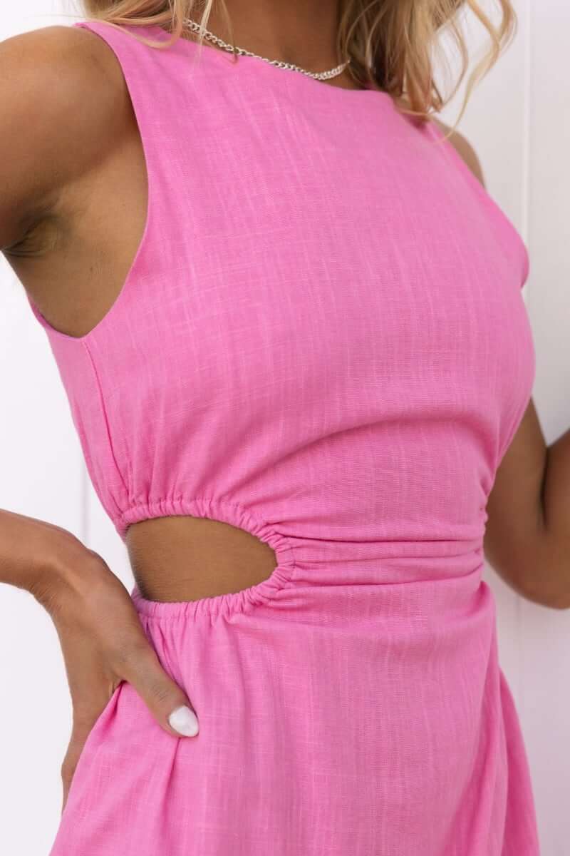 Close-up of a pink Havanna Dress featuring a round neckline and cut-out elastic side details.