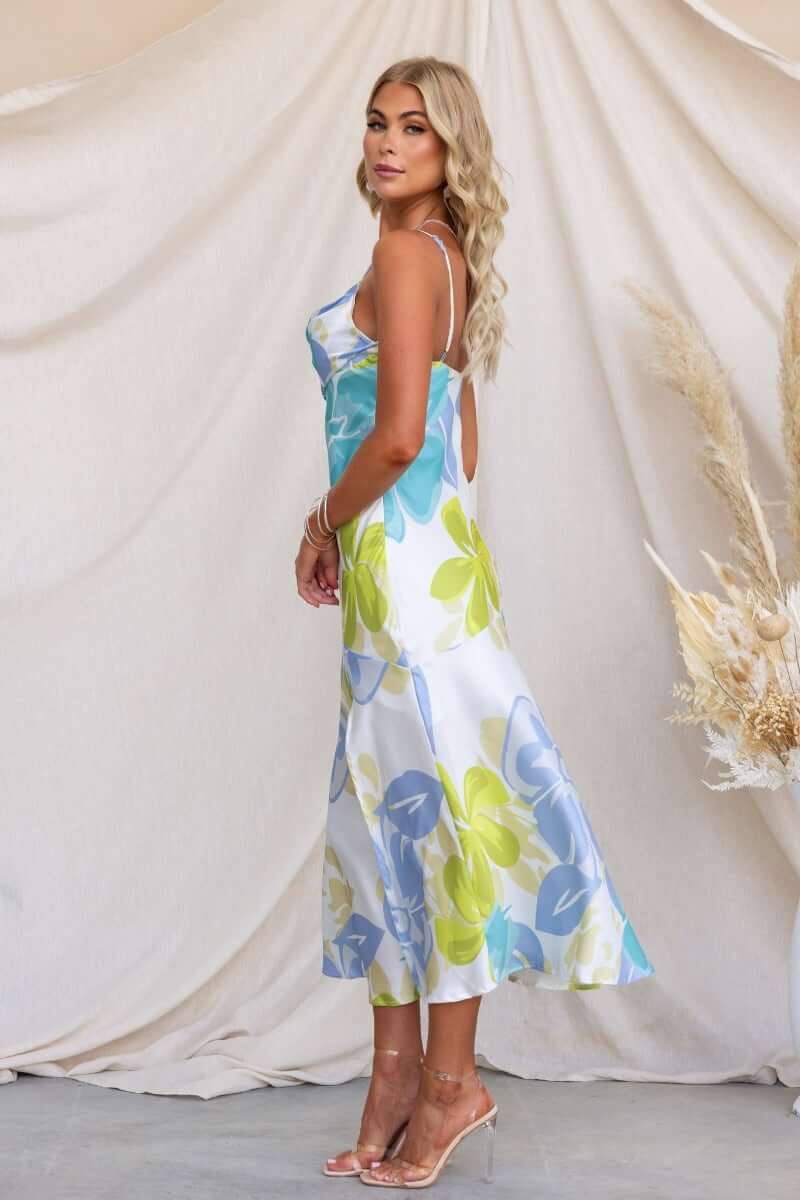 Model wears a floral print Brighton Midi Dress with adjustable straps and a split front, showcasing a satin look.