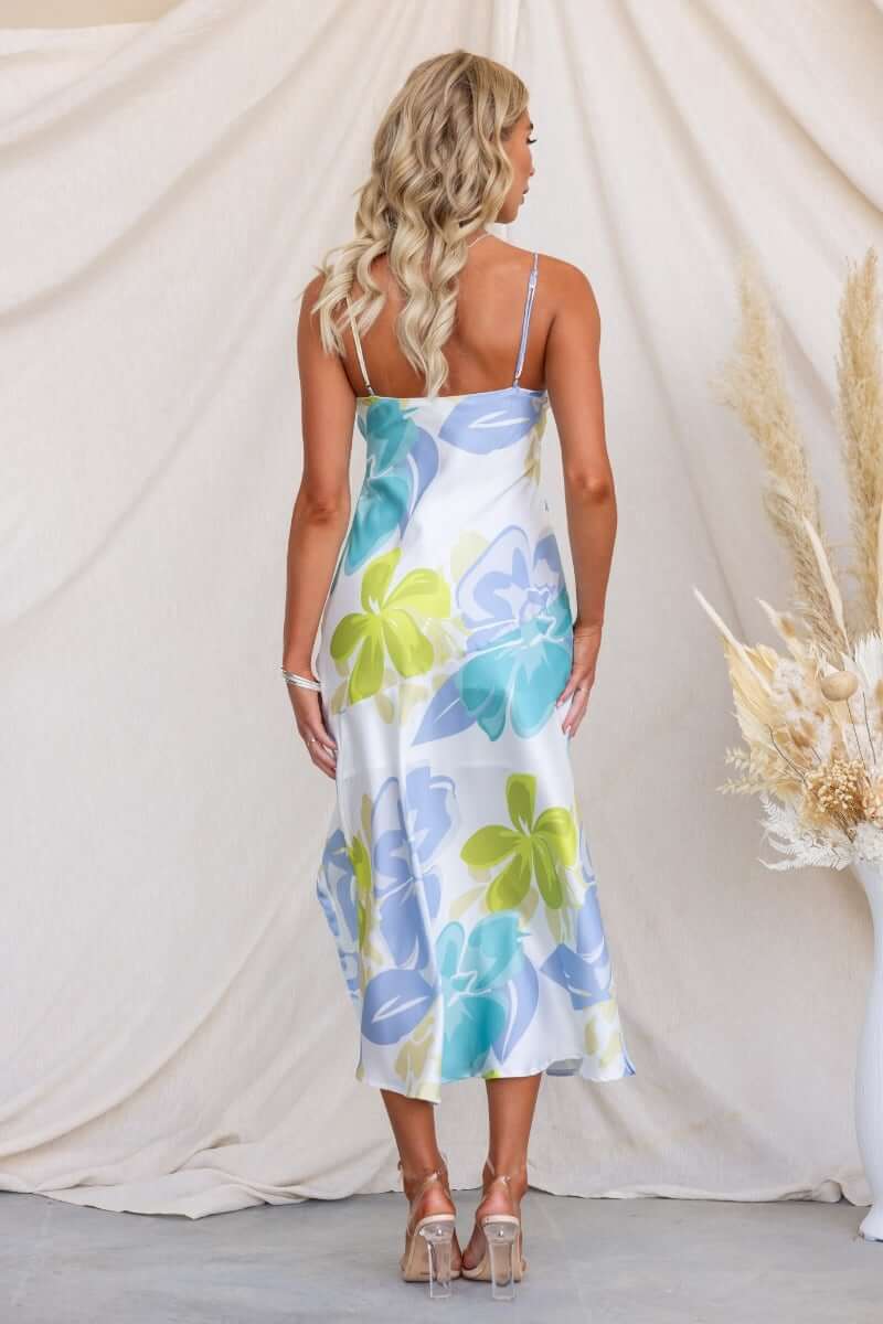 Woman wearing Brighton Midi Dress, floral print with adjustable straps and split front, showing back view.