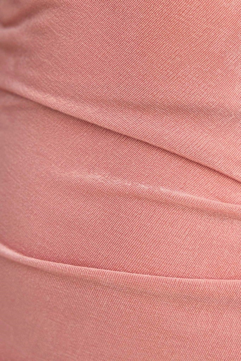 Close-up of slinky fabric in soft pink, showcasing ruching details of the Grady Maxi Dress.