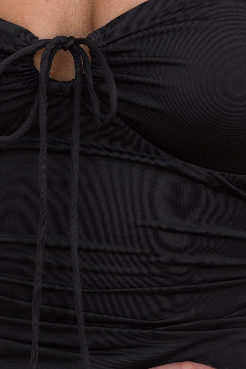 Close-up of Riri Midi Dress black strapless top with tie detail at bust and ruched fabric.