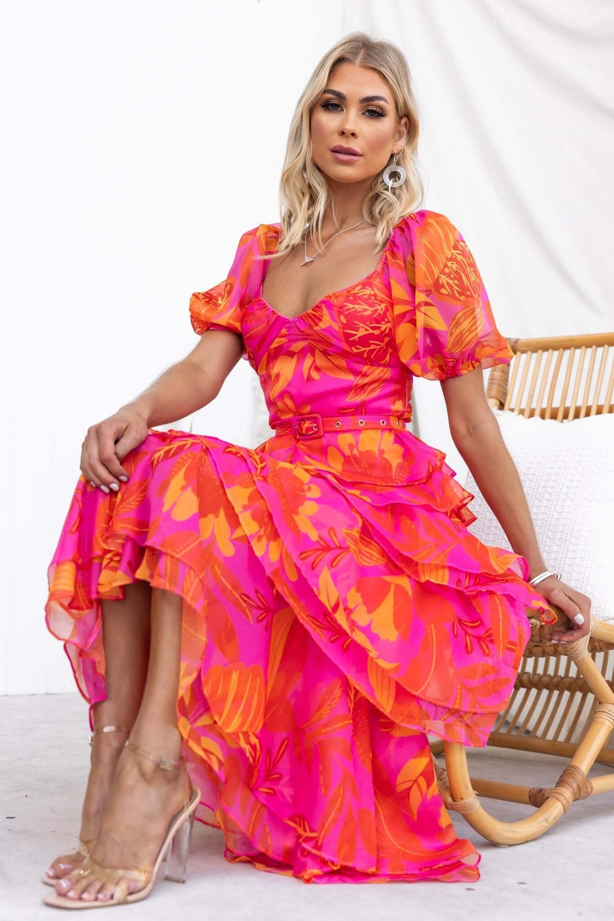 Favourable maxi dress in vibrant pink and orange floral chiffon, featuring ruffled skirt and removable belt.