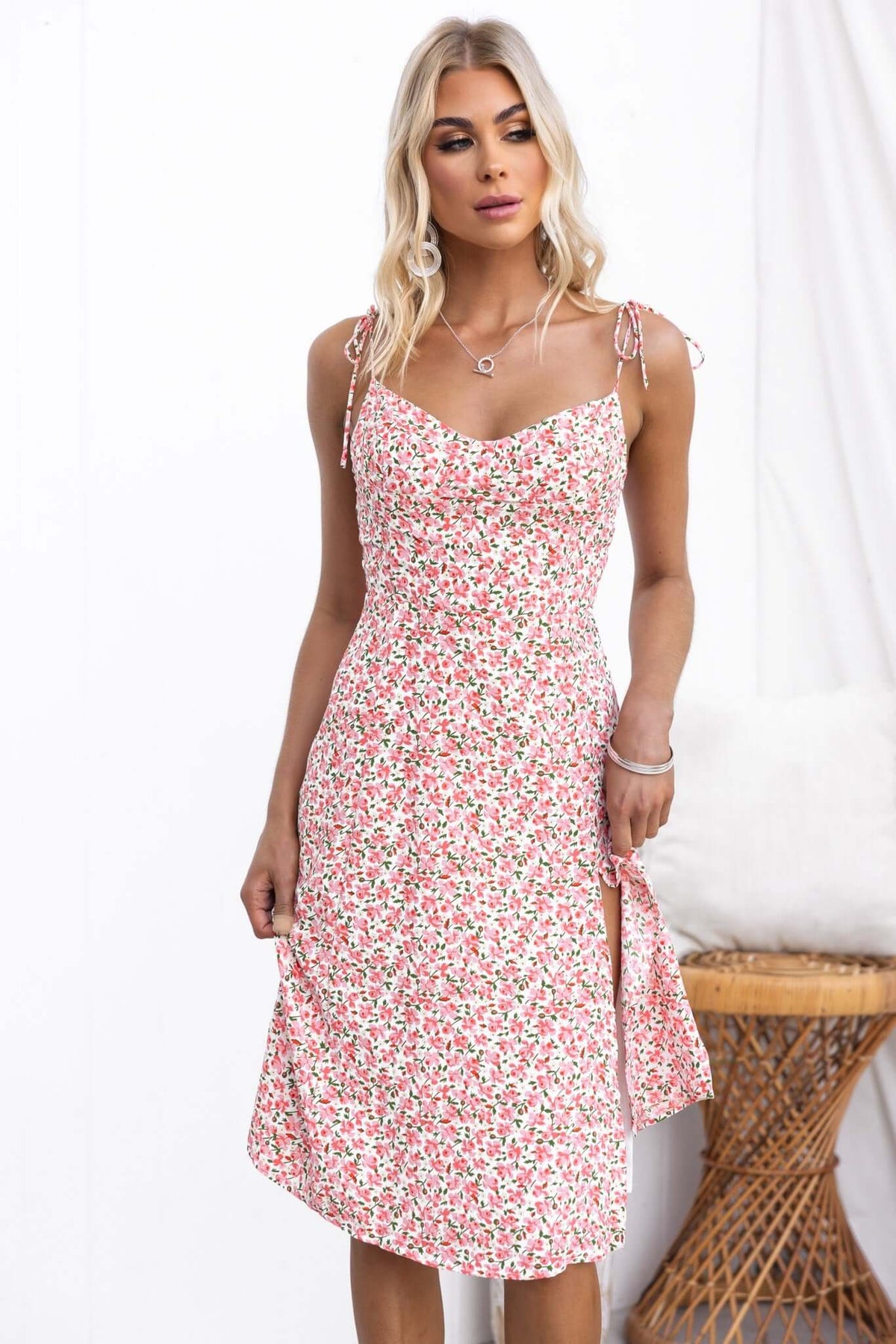 Model wearing Felicia Midi Dress with floral print, adjustable straps, split front, and elegant fit.
