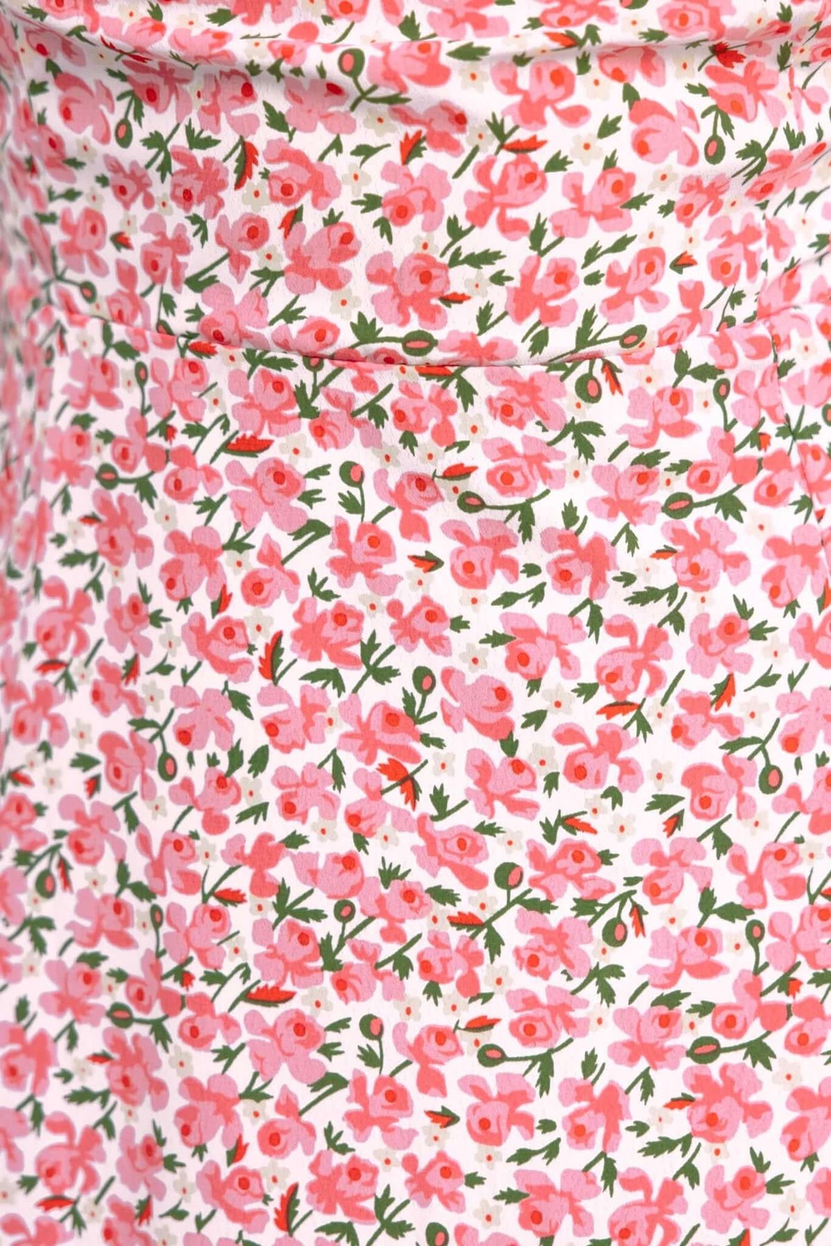 Close-up of pink floral print fabric on Felicia Midi Dress, showcasing vibrant flowers on a light background.