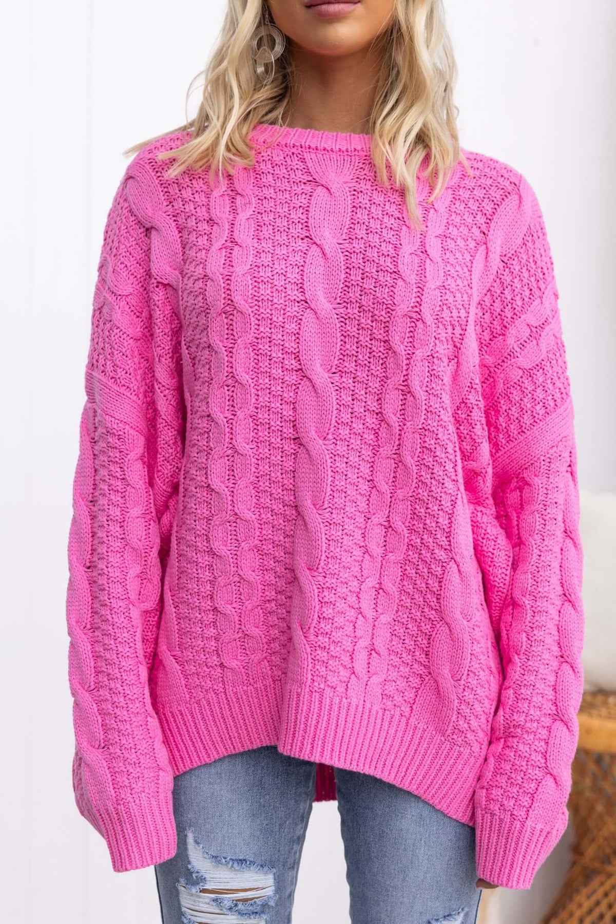 Pink Varese jumper with round neckline and cable knit design, featuring a relaxed fit and stretch material.
