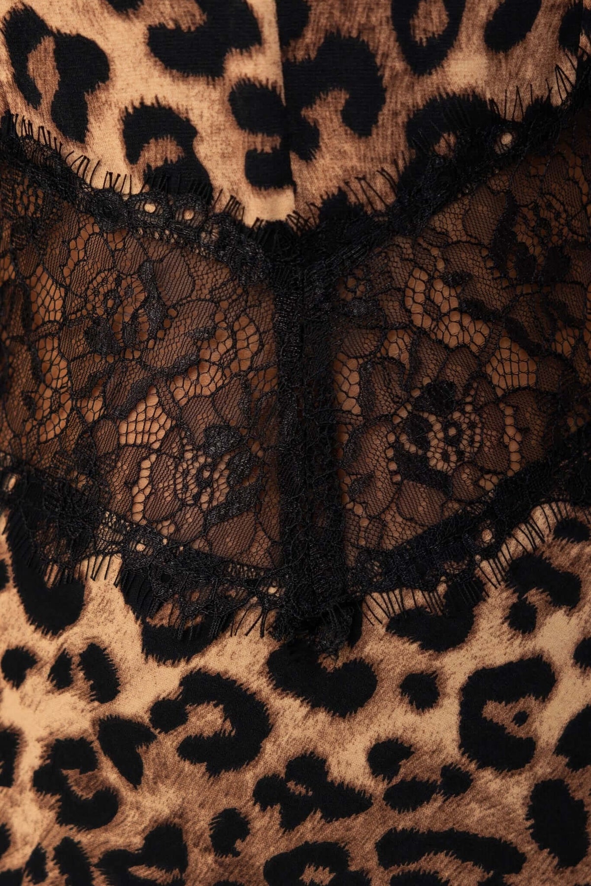 Close-up of black lace detail on a leopard print maxi dress, highlighting its stylish design and intricate texture.