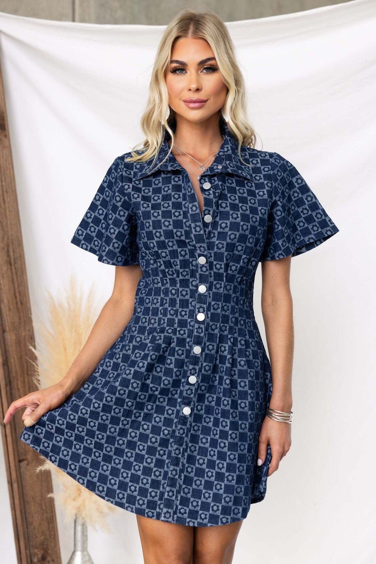 Mara Denim Dress featuring a collar, faux button-up front, and a flared skirt design in stylish denim fabric.