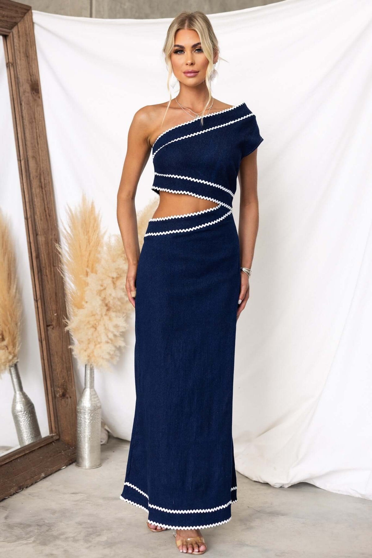 Favara Denim Maxi Dress featuring one-shoulder style, cut-out waist, and chic design in navy blue.