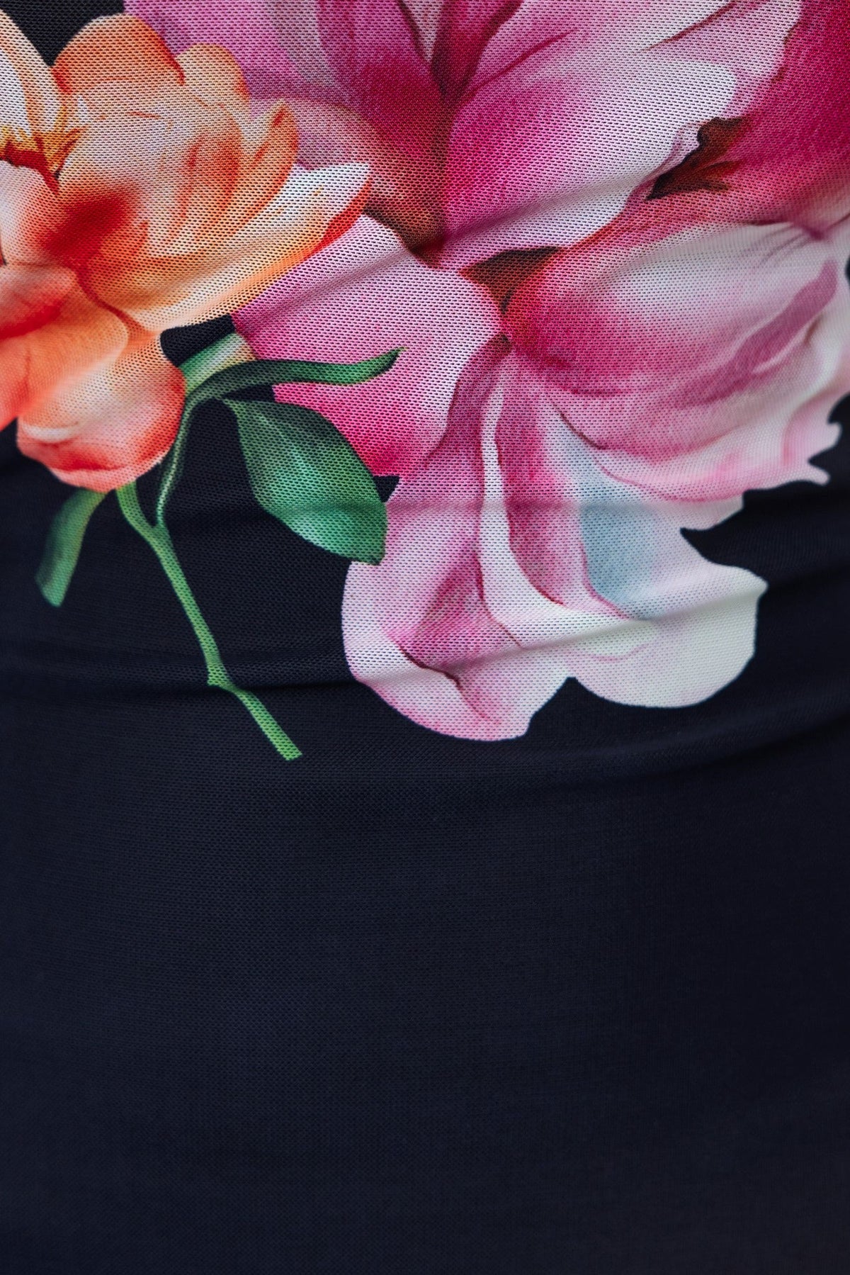 Close-up of vibrant floral design featuring pink and orange flowers on a black background.