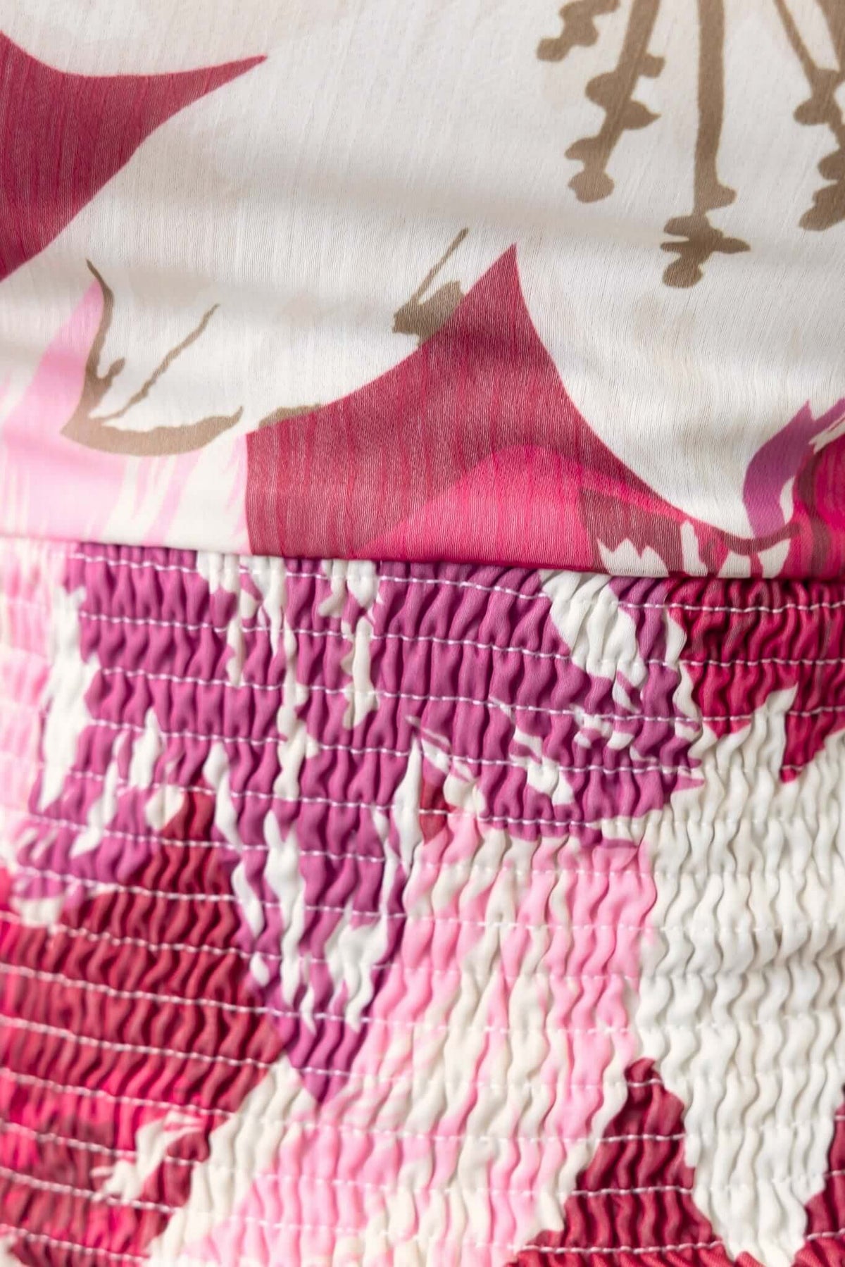 Close-up of floral patterned fabric in pink and red tones, showcasing the texture and detail of the Naples Midi Dress.