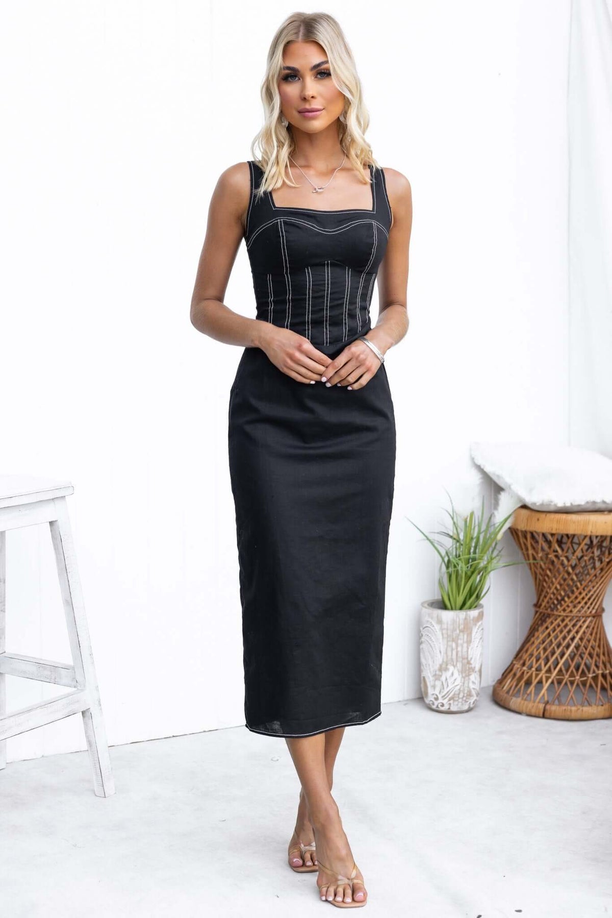 Elegant black Sebille Midi Dress with adjustable straps and an invisible back zip, featuring a split at the back.