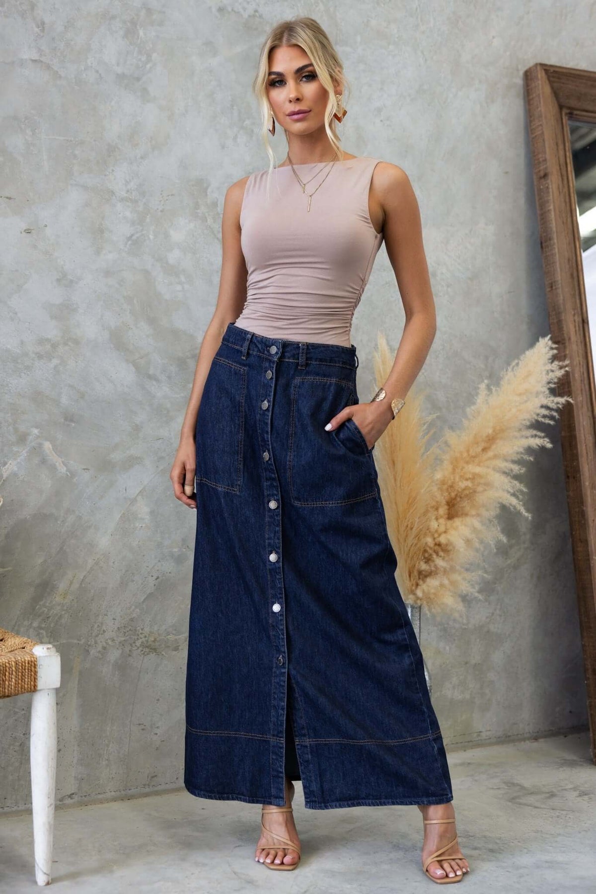 Model wearing a cotton blend Pavia Top with a boat neckline paired with a denim skirt, showcasing a trendy outfit.