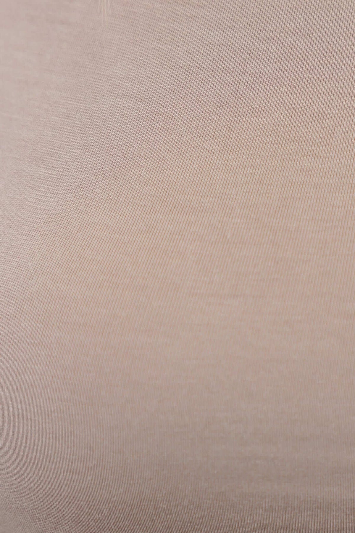 Close-up of soft cotton blend fabric in a beige hue, showcasing its smooth texture for the Pavia Top.