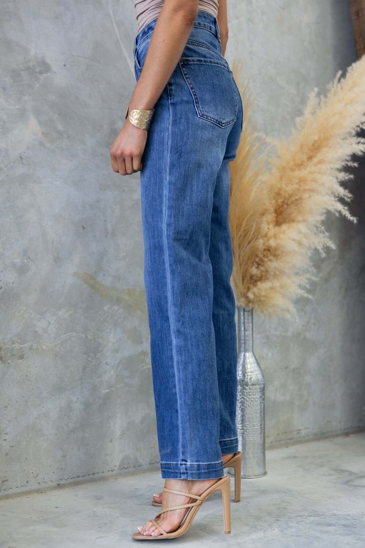 Model wearing Tonic Jeans with a mid-high waist, straight leg fit, showcasing a casual style against a neutral backdrop.