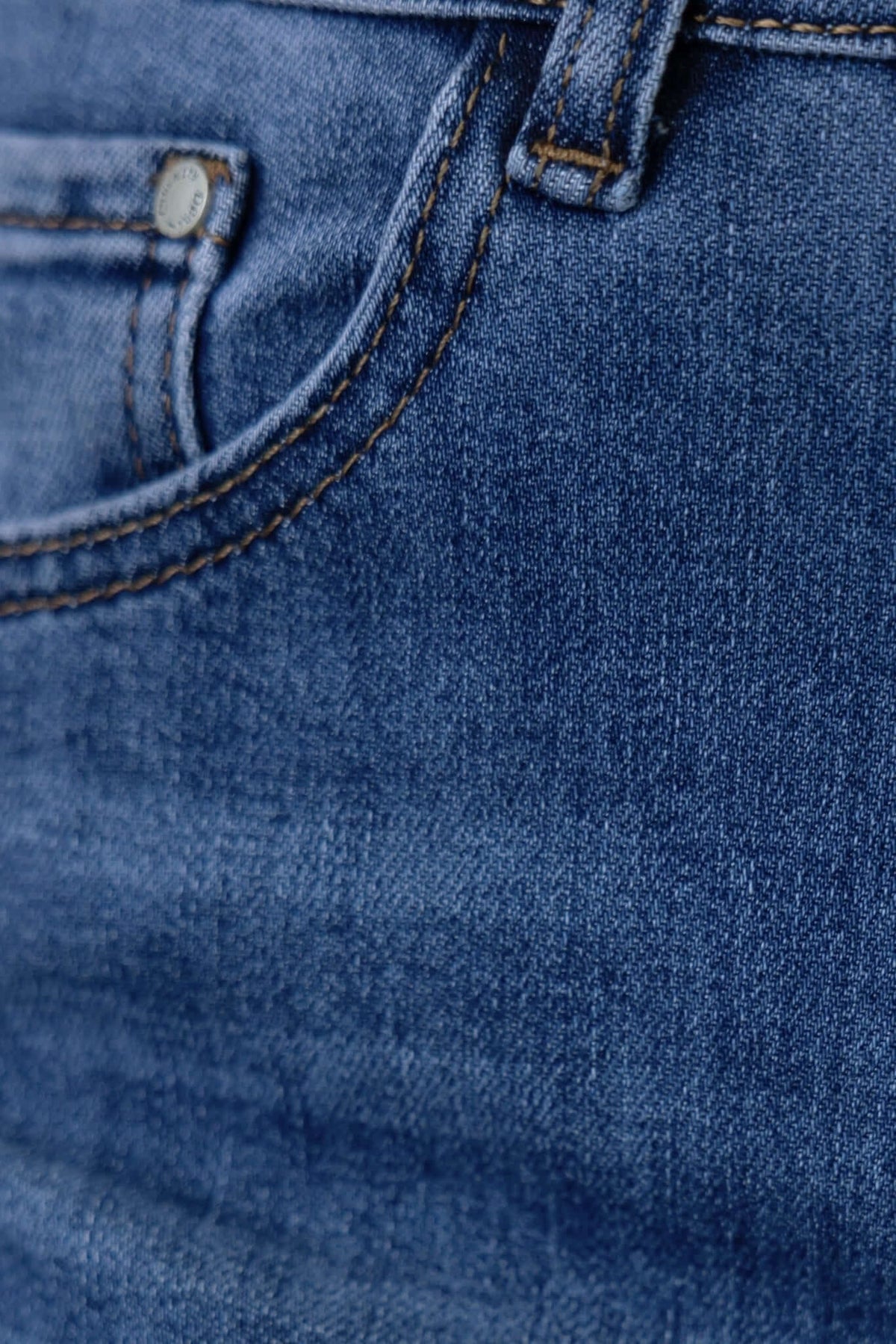 Close-up of Tonic Jeans pocket detail, featuring mid-high waist straight leg fit and durable denim fabric.