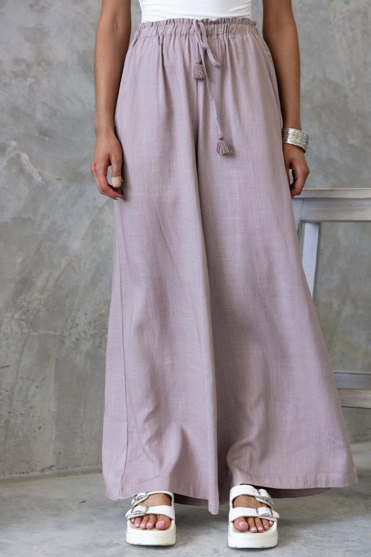 Marcia Pants in soft lavender with elastic waistband and drawstring, styled with white sandals.