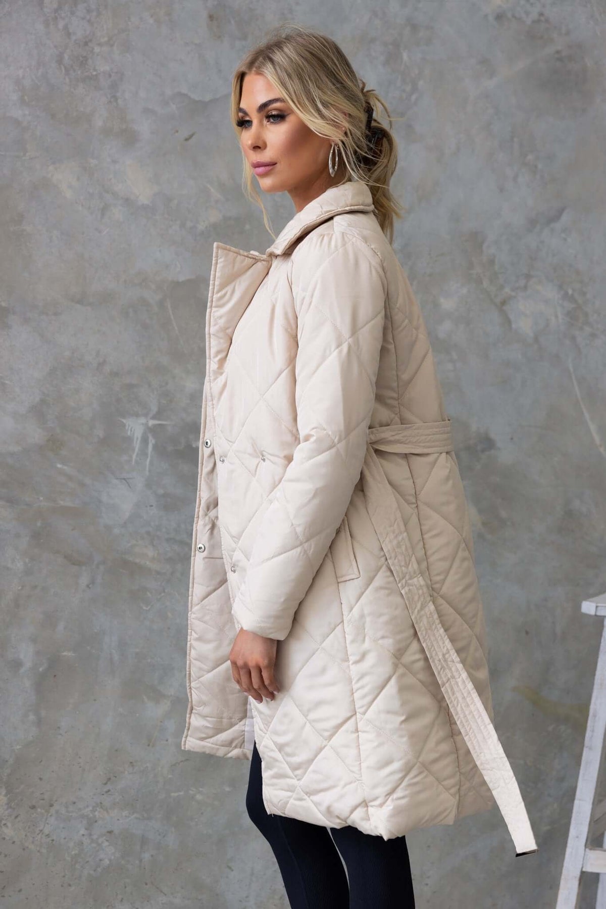 Chantel Coat in beige, featuring a longline fit, quilted style, and removable tie, displayed on a model.