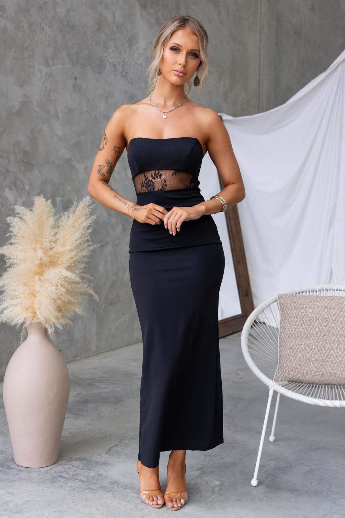 Sassari Maxi Dress in black, strapless with lace panel and back split, showcasing elegance and comfort.