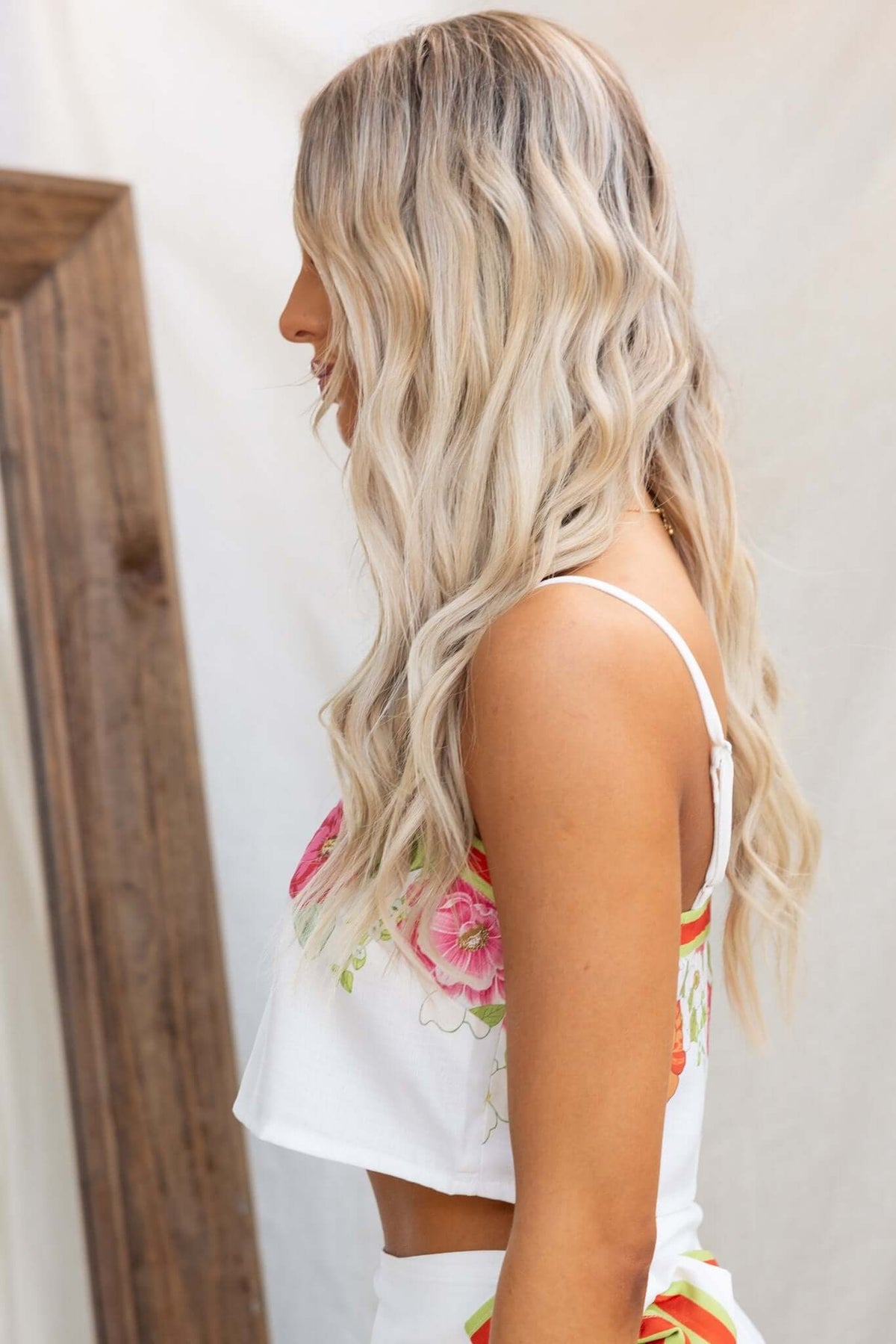 Julissa Top with adjustable straps, featuring floral design, model showcasing side view, perfect for summer styling.
