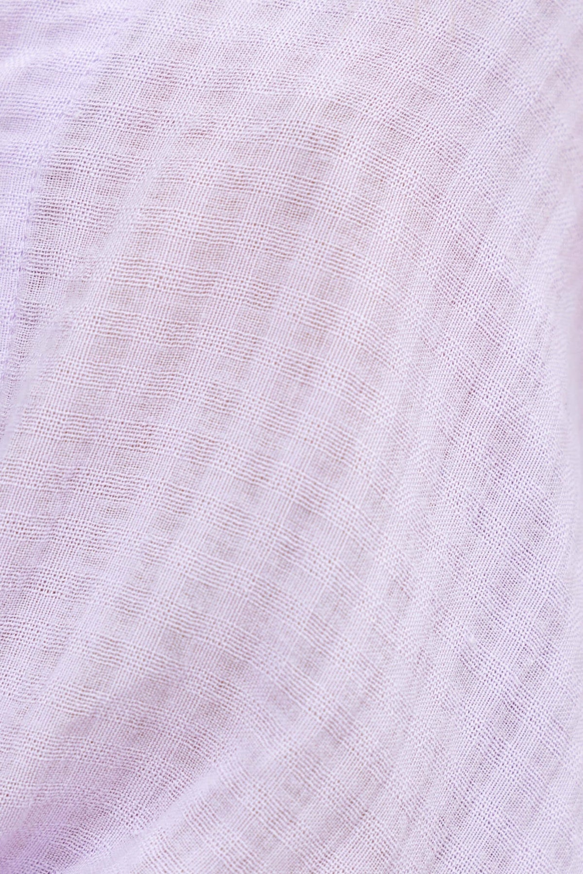 Close-up of soft lavender fabric with a textured grid pattern, ideal for casual wear and stylish tops.