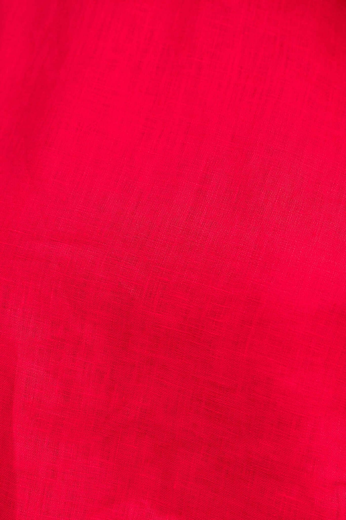 Close-up of vibrant pink linen fabric displaying a soft, textured surface for a stylish top.