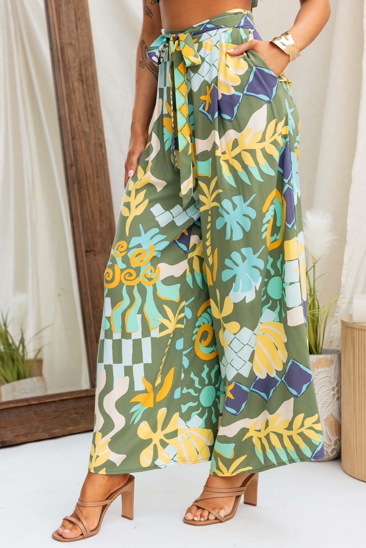 Warana Pants featuring a mid-high waist fit with a removable tie and vibrant patterned design, ideal for a stylish summer look.