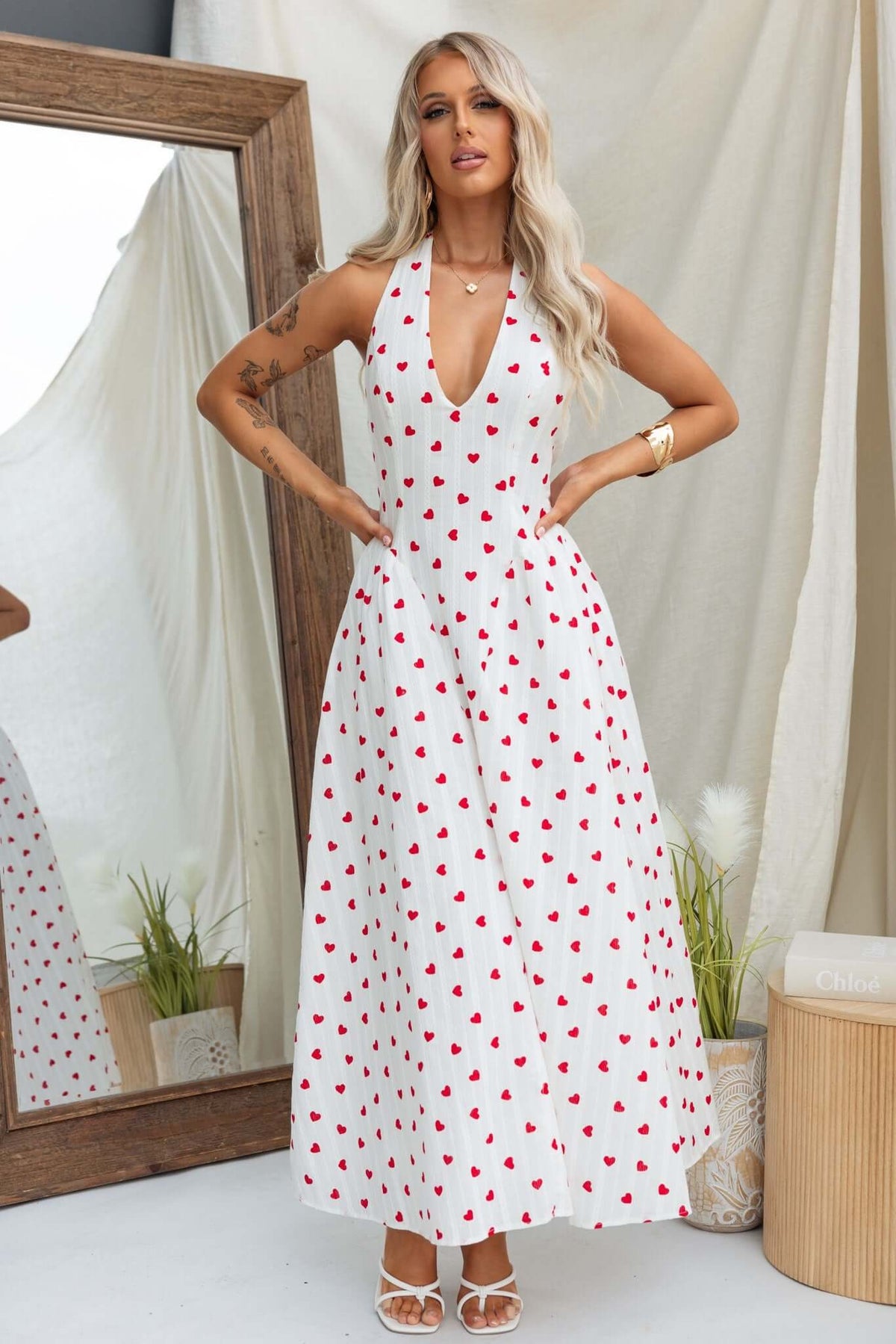 Model wearing Imarnie Maxi Dress with tie neckline and heart print, featuring a tulle underlay and invisible zip.