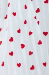 Image of a white fabric featuring small red hearts, perfect for a romantic design or dress detail.