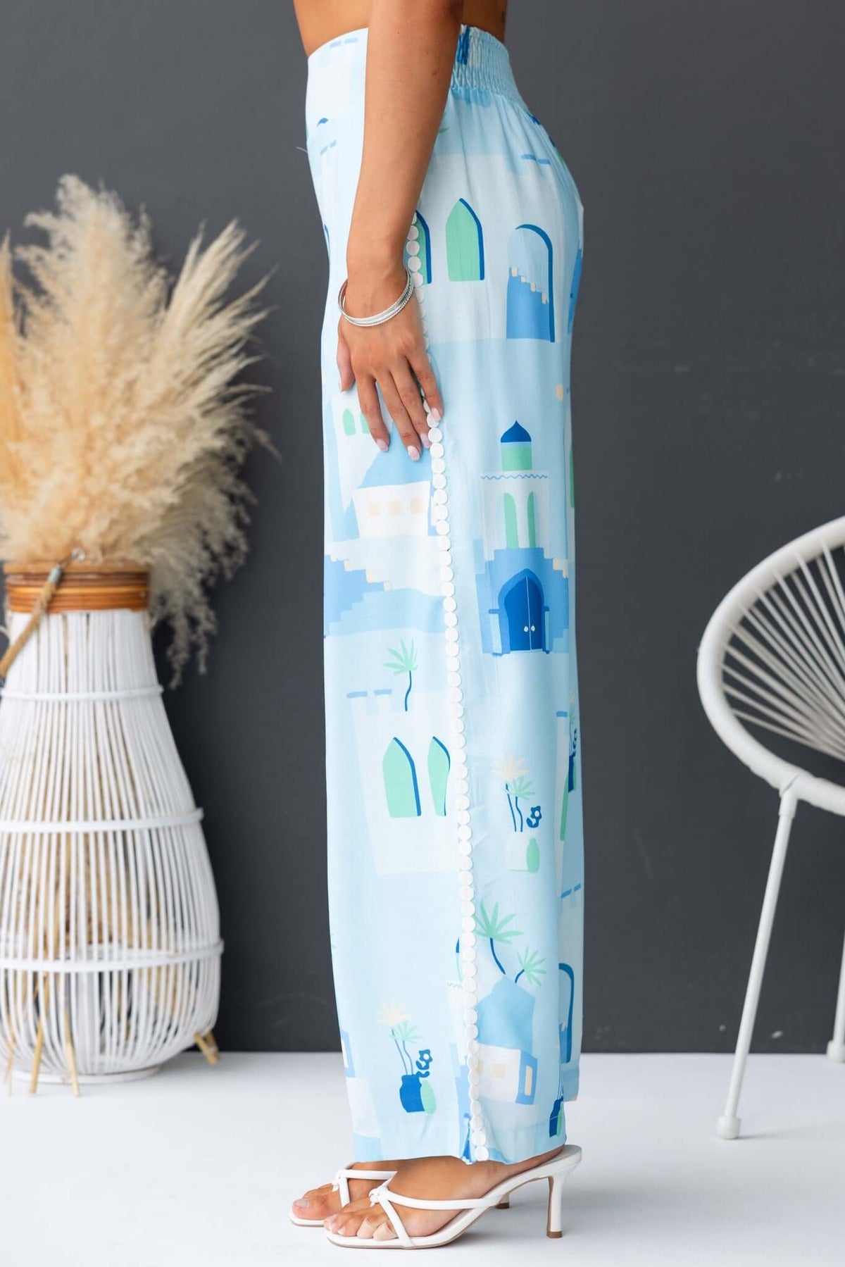 Stylish Uriela Pants with a mid-high waist, elastic waistband, and colorful blue graphic design.