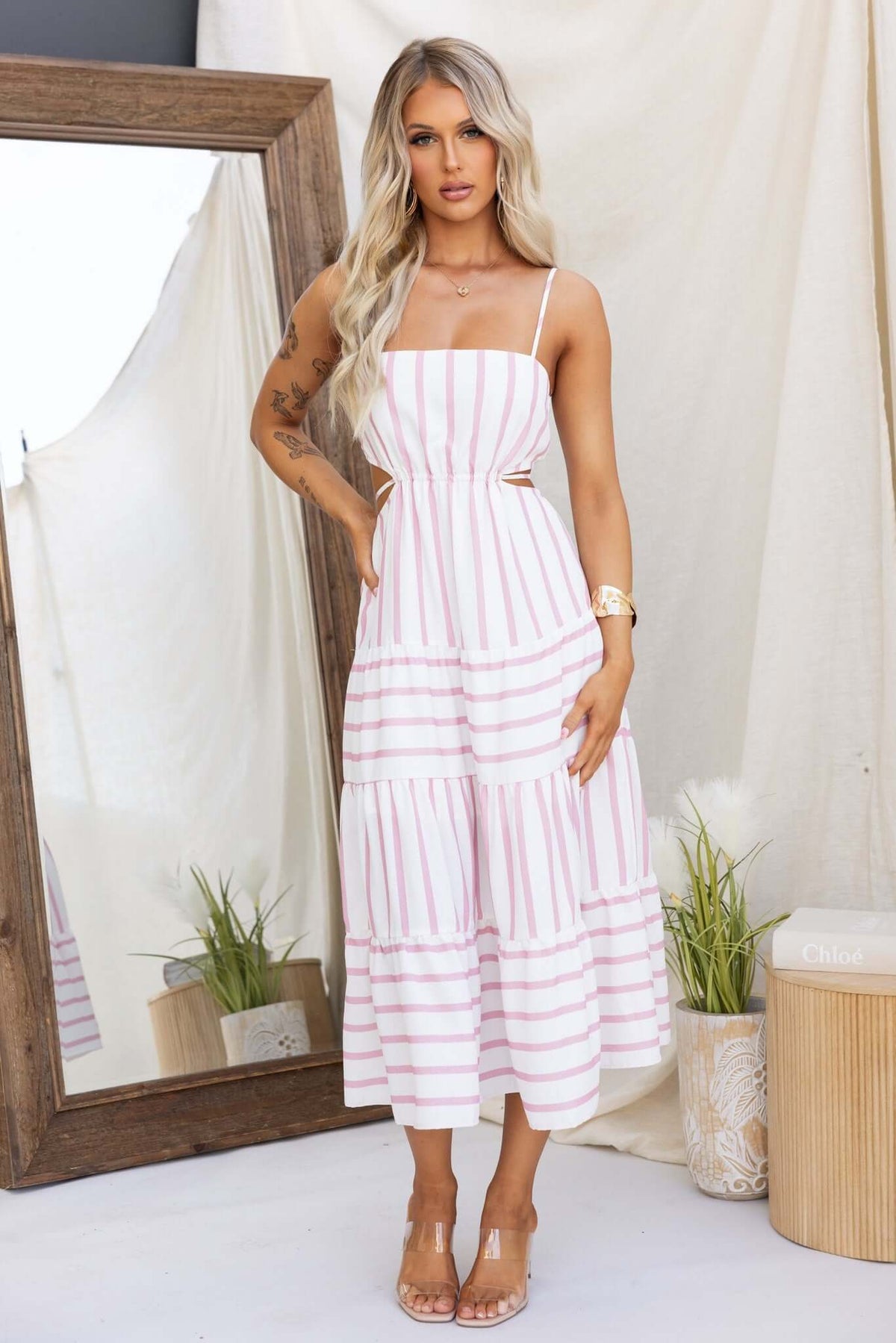 Brookman Midi Dress featuring adjustable straps, cut-out waist, and linen look in white and pink stripes.