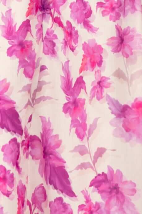 Close-up of floral print in shades of pink and purple on soft fabric, ideal for a stylish maxi dress.