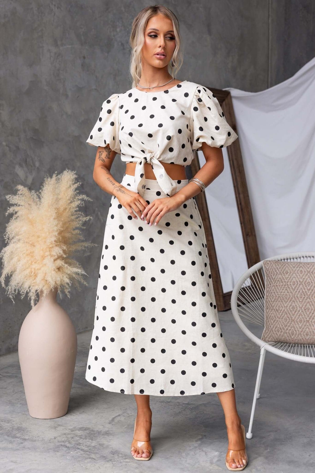 Carrion Midi Skirt in polka dots, featuring a mid-high waist, elastic waistband, and pockets, styled with a matching top.