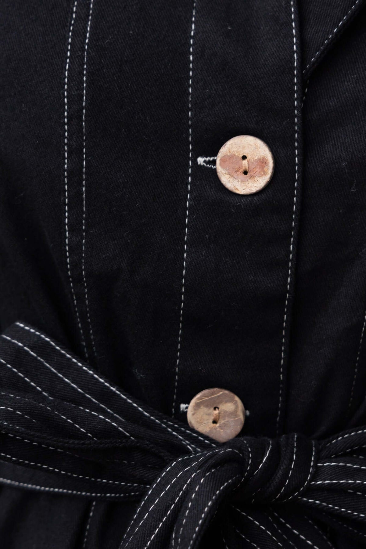 Close-up of Tied In Denim Dress featuring button-up front and fabric tie detail.