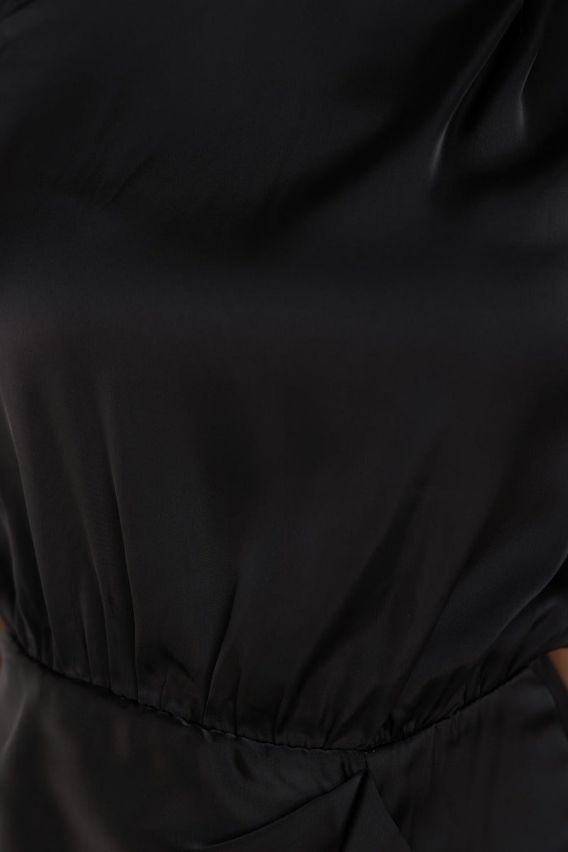 Close-up of the black satin Lights Out Dress showcasing the smooth fabric and elastic waistband design.
