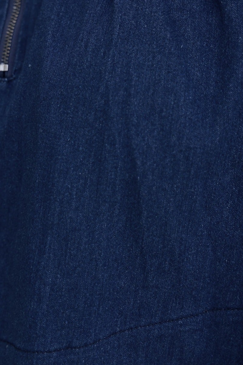 Close-up of the fabric texture of Cannie Denim Dress featuring rich blue denim and a smooth finish.