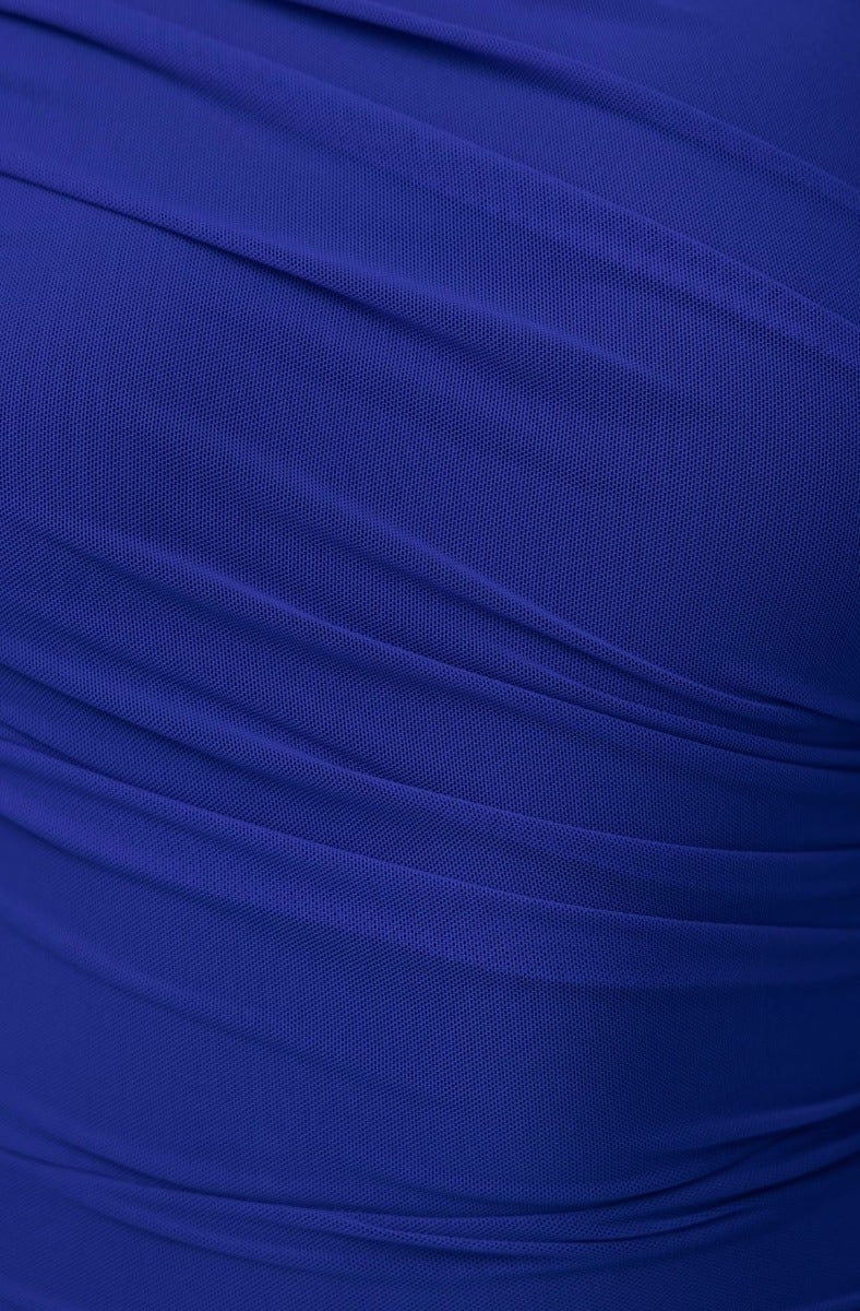 Close-up of blue mesh overlay fabric with ruching, showcasing texture and stretch for the Xylan Dress.