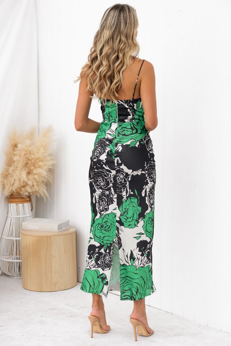 Back view of Shana Maxi Dress featuring black and green floral design, adjustable straps, and split detail at the back.
