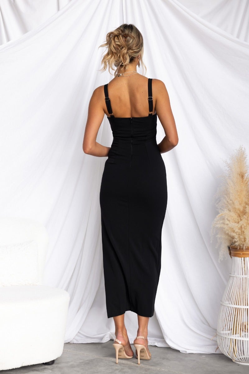 Back view of black bodycon midi dress with adjustable straps and mesh detail, perfect for a chic evening look.
