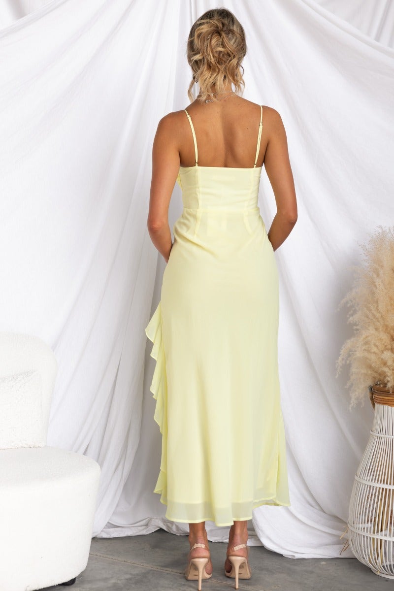 Back view of Cinzia Yellow Maxi Dress featuring adjustable straps and side ruffle trim.